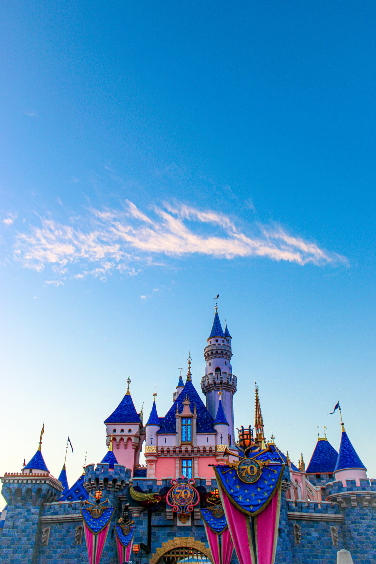 Castle turrets and celebratory banners beneath a wide blue sky