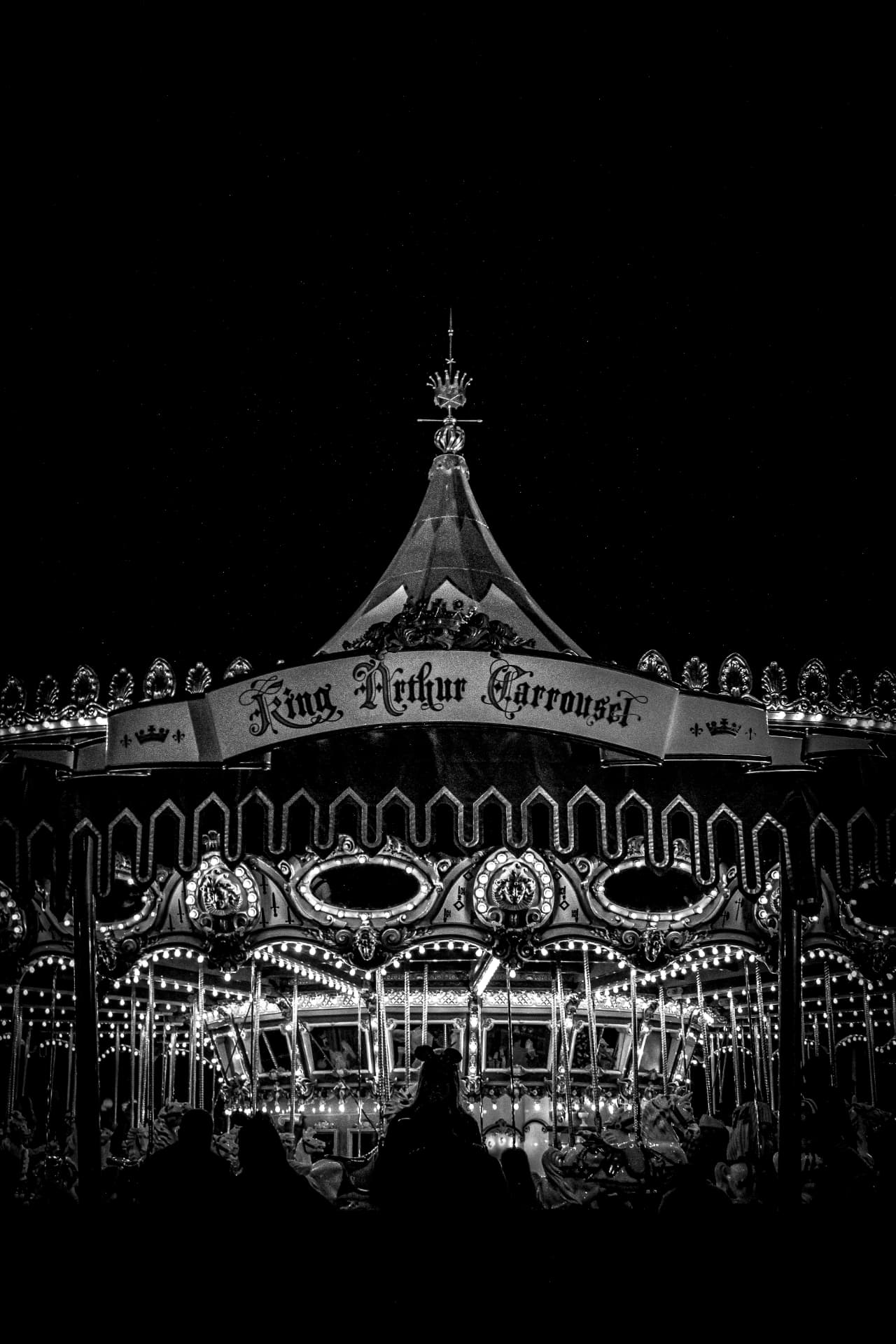King Arthur Carrousel glowing in black and white at night