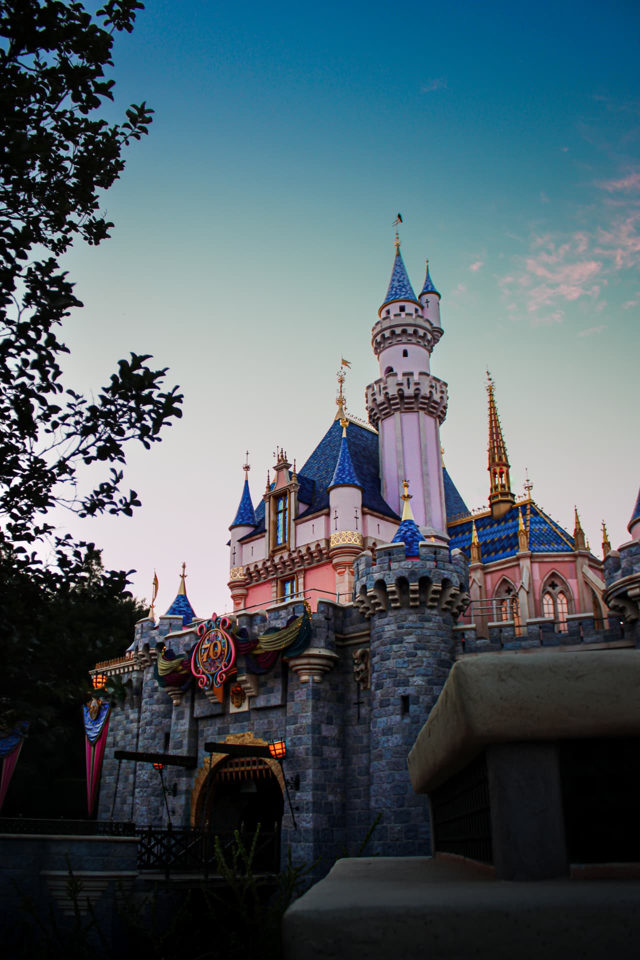 Fairytale castle under pink evening clouds at dusk